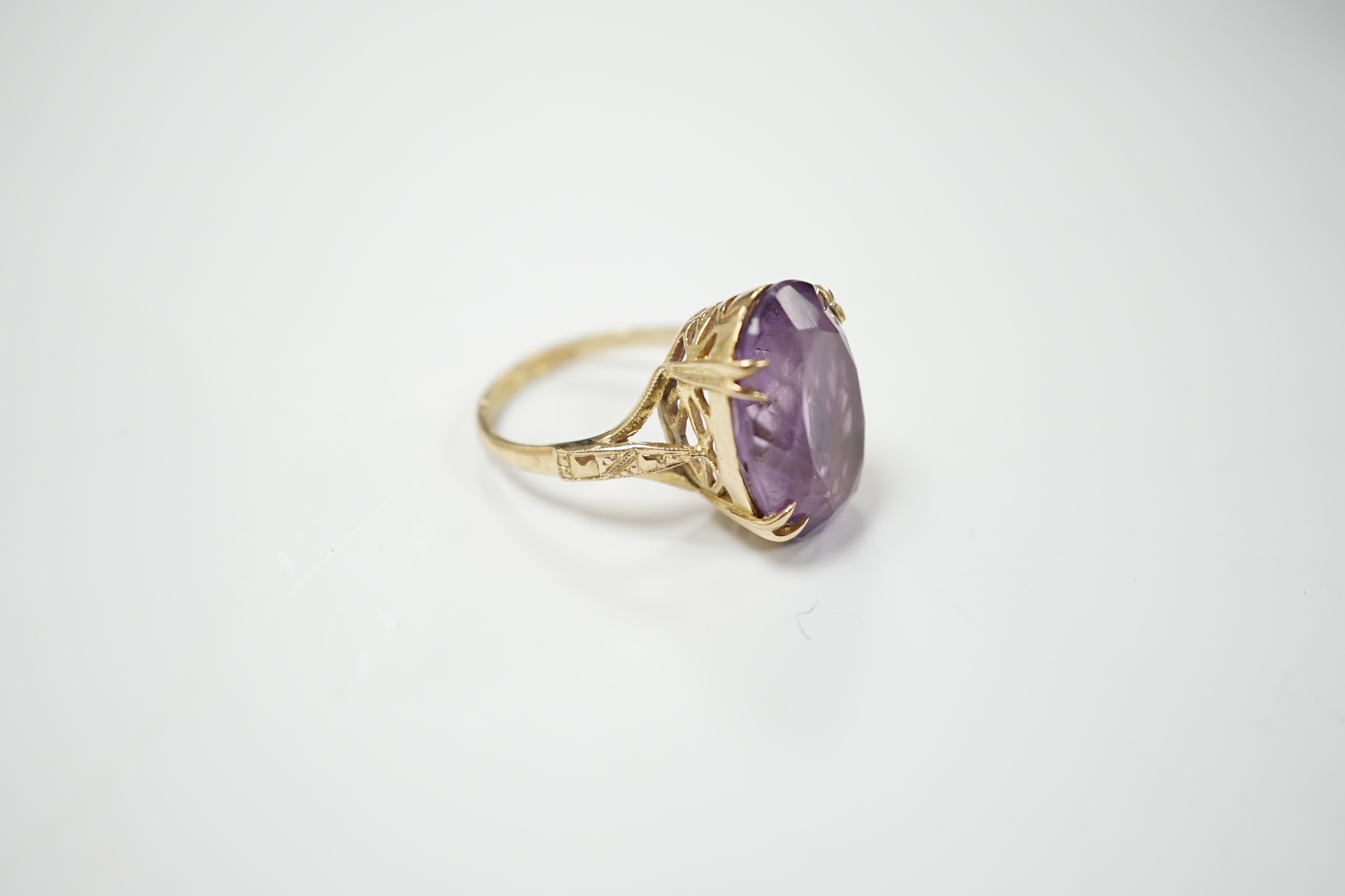 A modern 9ct gold and oval cut amethyst set dress ring, size M, gross weight 5.9 grams.